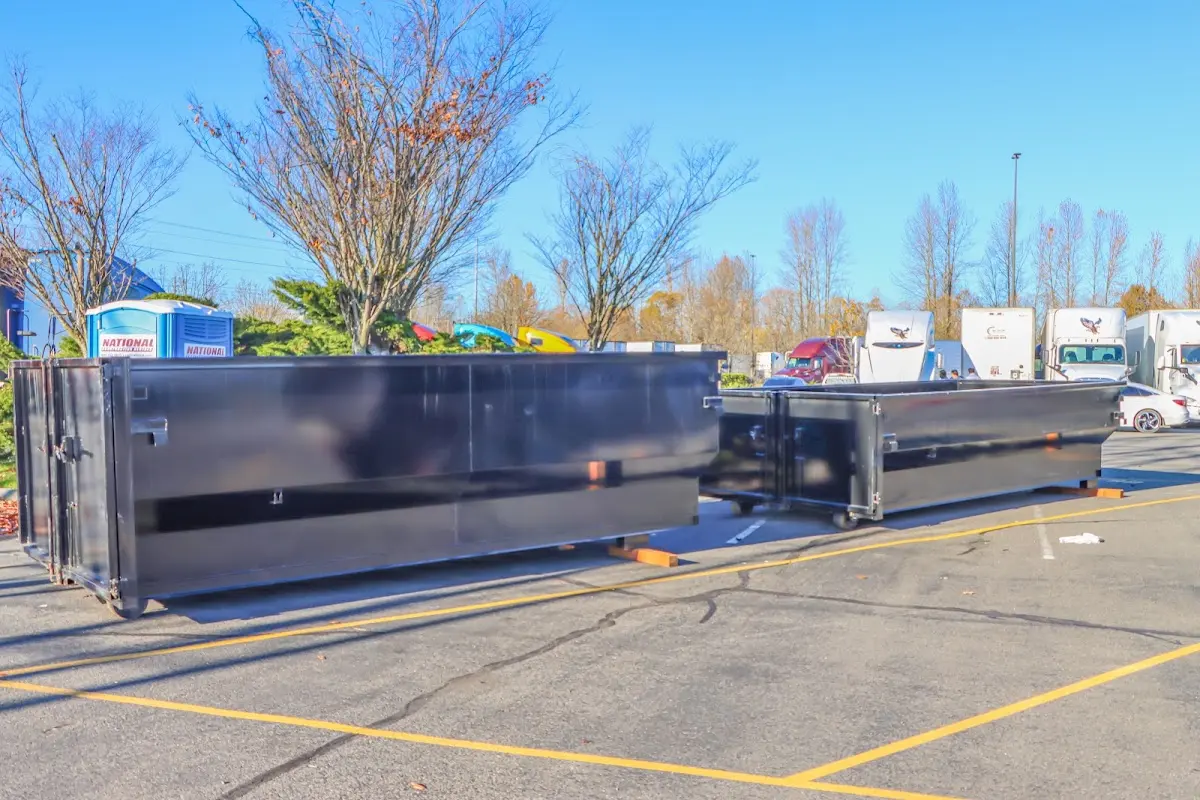 Professional dumpster rental service with roll-off container on residential driveway in Newfane